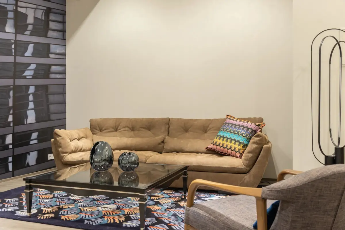 A bright living room with cushions and decor, representing a home decorating advice site